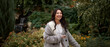 © olga pink - Portrait of pretty asian kazakh brunette woman with charming smile walking along outdoors