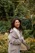 © olga pink - Portrait of pretty asian kazakh brunette woman with charming smile walking along outdoors
