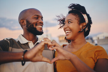 Wall Mural - Black couple, heart hand and celebrate relationship being happy, smile and romantic outdoor together. Love, man and woman smile, relax and on holiday and vacation for bonding, anniversary or romance.