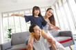 © aekkorn - Happy family with daugther having fun in living room at home.