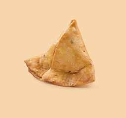 Samsa or samosas with meat and vegetables isolated on brown background. Traditional Indian food.