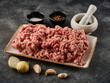 Fresh pork minced meat on grey background. Raw minced meat on the plate. Raw minced pork
