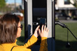 © Westend61 - Woman making payment through smart phone at vehicle charging station