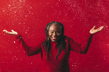 Wall Mural - Excited mature woman celebrating with confetti