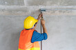 © Pormezz - construction worker and contractor. Electrician prepare to wire electric system on the ceiling in reconstruction room.