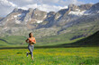 © Antonioguillem - Runner woman running in a green field in the high mountain