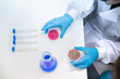 © Westend61 - Scientist holding petri dishes with fungus over table in laboratory
