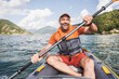 © Westend61 - Cheerful mature man enjoying kayaking at lake