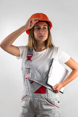 Wall Mural - Female foreman in uniform posing for camera on isolated monotone background.