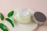 Fototapeta  - Open jar of body moisturizer. Moisturizing cream white packaging mockup. The concept of natural beauty products for spa treatments.