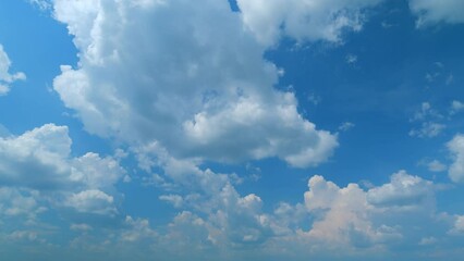 Wall Mural - Blue sky white puffy fluffy clouds billow in high space. Sky with clouds weather. Time lapse.