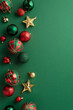 © ActionGP - Christmas tree decorations concept. Top view vertical photo of star ornaments gold green and red baubles on isolated green background