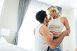 © Kawee - Caucasian young man and woman starting foreplay and making love on bed