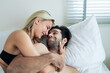 Caucasian young man and woman starting foreplay and making love on bed