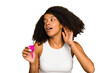 © Asier - Young African American woman holding a menstrual cup isolated trying to listening a gossip.