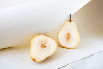 Wall Mural - Ripe juicy pears on white color linen tablecloth.