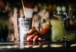 man hand bartender pouring cocktail in shaker on the bar counter