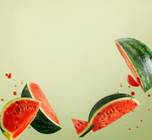 Flying Watermelon Slices With Juice Splash At Light Green Background. Creative Food Levitation