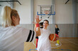 © Halfpoint - Group of multiaged women, sports team players, in gym celebrating victory.