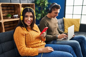 Canvas Print - Man and woman couple using laptop and listening to music at home