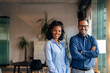 © bnenin - Portrait of two business partners, posing together, for the camera with hands crossed.
