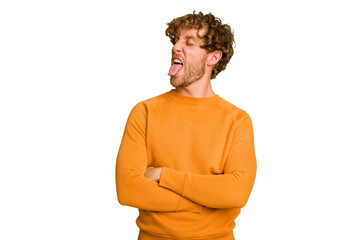 Wall Mural - Young caucasian man isolated on green chroma background funny and friendly sticking out tongue.