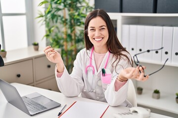 Poster - Young woman wearing doctor uniform speaking at clinic