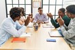 © Krakenimages.com - Group of african american business workers smiling and clapping to partner at the office.