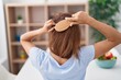 © Krakenimages.com - Young woman combing hair at home