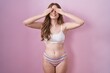 © Krakenimages.com - Caucasian woman wearing lingerie over pink background covering eyes with hands smiling cheerful and funny. blind concept.