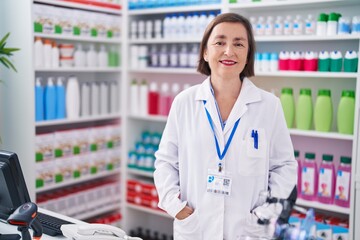 Poster - Middle age woman pharmacist smiling confident standing at pharmacy