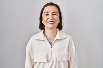 Wall Mural - Middle age hispanic woman standing over isolated background with a happy and cool smile on face. lucky person.