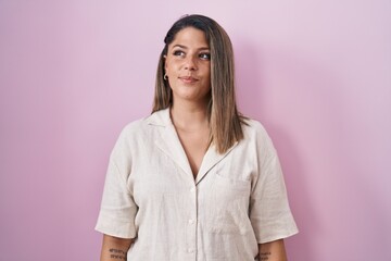 Canvas Print - Blonde woman standing over pink background smiling looking to the side and staring away thinking.