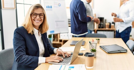 Sticker - Middle age business worker smiling happy working while partners have break time at the office.