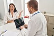 © Krakenimages.com - Young hispanic woman at the doctor celebrating victory with happy smile and winner expression with raised hands
