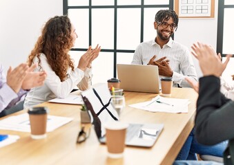 Wall Mural - Group of business workers smiling and clapping to partner at the office.