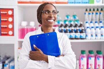 Canvas Print - african american woman pharmacist smiling confident holding clipboard at pharmacy