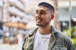 © Krakenimages.com - Young hispanic man smiling confident standing at street
