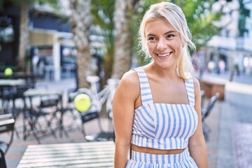 Sticker - Young blonde girl smiling happy standing at the city.