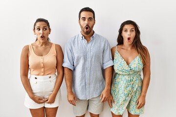 Poster - Group of young hispanic people standing over isolated background scared and amazed with open mouth for surprise, disbelief face