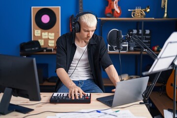 Sticker - Young caucasian man musician having dj session at music studio