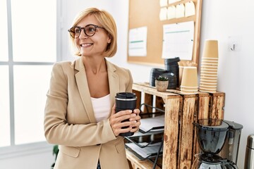 Sticker - Middle age blonde woman smiling confident drinking coffee at office