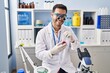 © Krakenimages.com - Young hispanic man scientist looking gemstone by magnifying glasses at laboratory