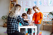 © Татьяна Волкова - Development class for math, alphabet and logic. Teacher with children having fun and learning in kid development center
