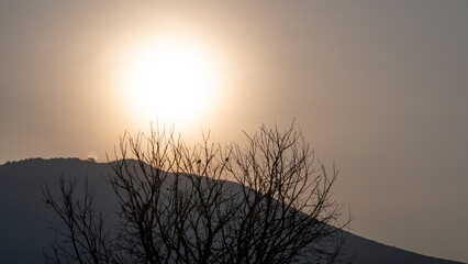 Wall Mural - Photograph of a sunrise over the mountains, first ray of sun