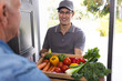 © wavebreak3 - Happy senior caucasian men opening house door and welcoming courier with vegetables