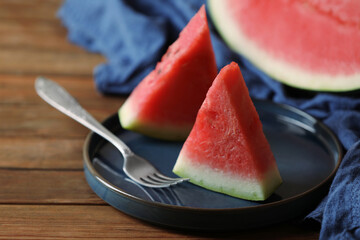 Sliced fresh juicy watermelon served on wooden table, closeup