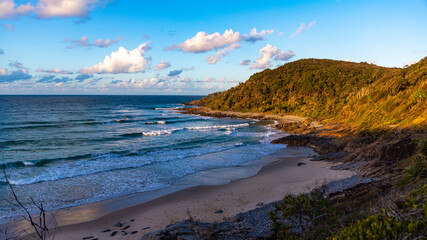 colourful sunset in noosa national park in queensland, australia; famous surf beaches in australia, silhouettes of surfers at sunset