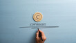 Circled letter C on a wooden cut circle with male hand writing a Copyright word under it