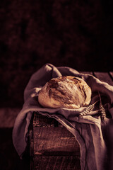 Canvas Print - Homemade bread and cloth napkin at table. Bakery concept on wood tabletop